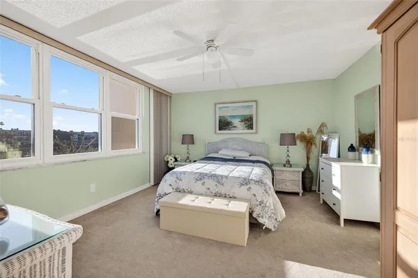 a spacious bedroom with a bed and a window