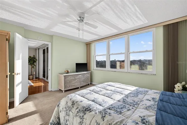 a bedroom with a large bed and a large window