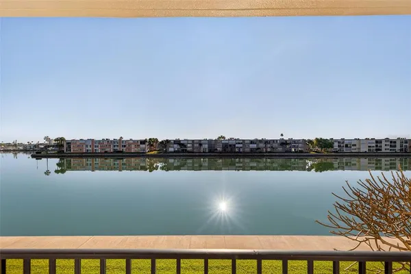 a view of a lake with houses in the back