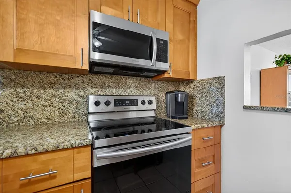 a kitchen with a stove and a microwave