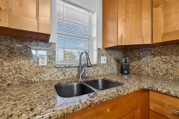 a kitchen with sink and cabinets
