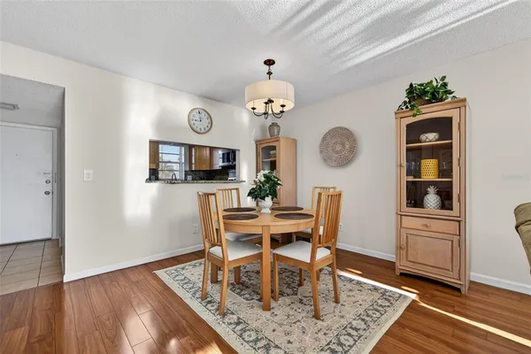 a view of a dining room with furniture and wooden floor
