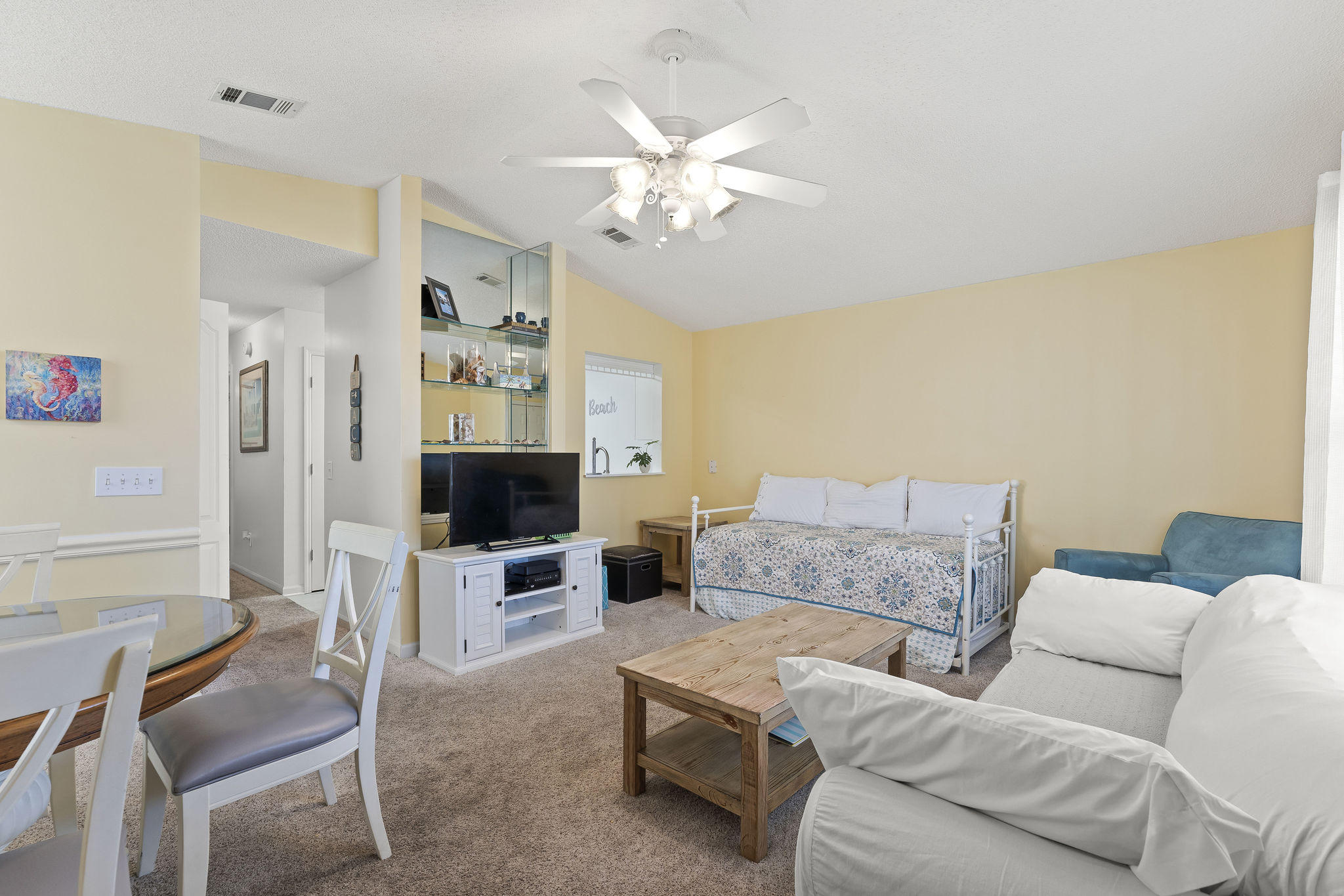 17462 Front Beach Road, Unit 77H Panama City Beach, FL 32413 - Photo 3 of 28 a living room with furniture a flat screen tv and white walls