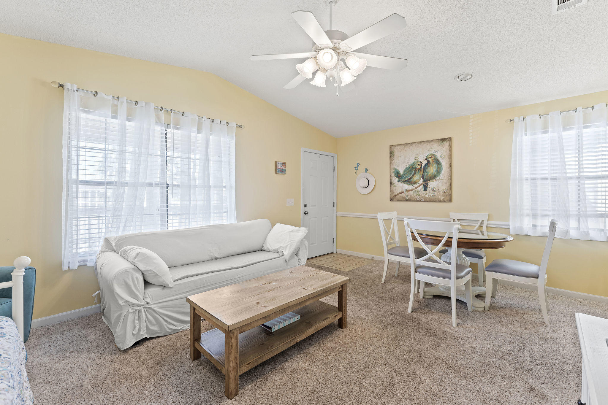 17462 Front Beach Road, Unit 77H Panama City Beach, FL 32413 - Photo 6 of 28 a living room with furniture a chandelier and a window