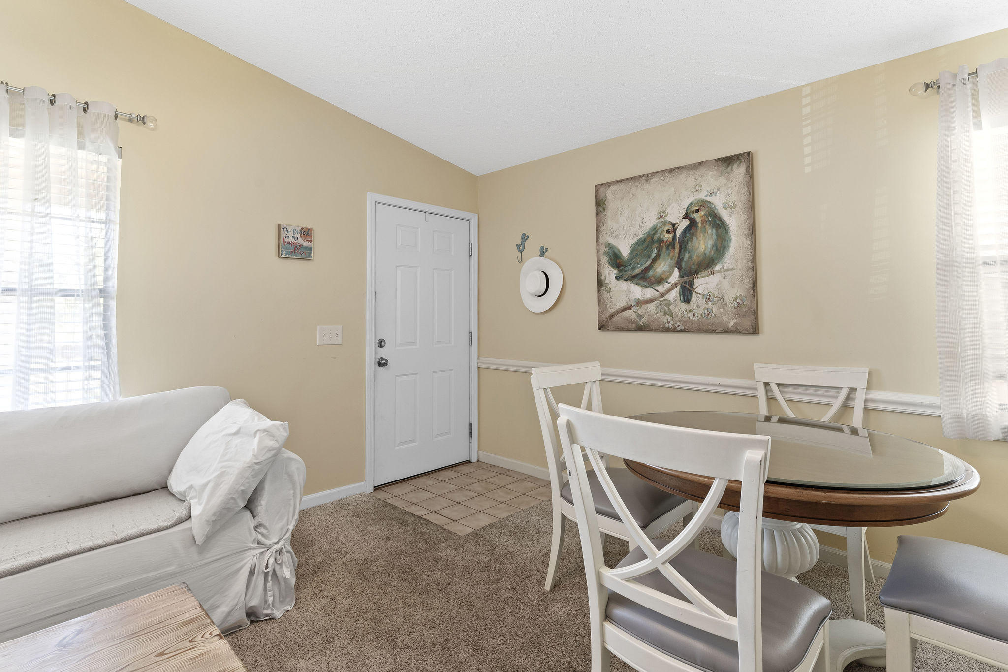 17462 Front Beach Road, Unit 77H Panama City Beach, FL 32413 - Photo 7 of 28 a dining room with furniture and a window