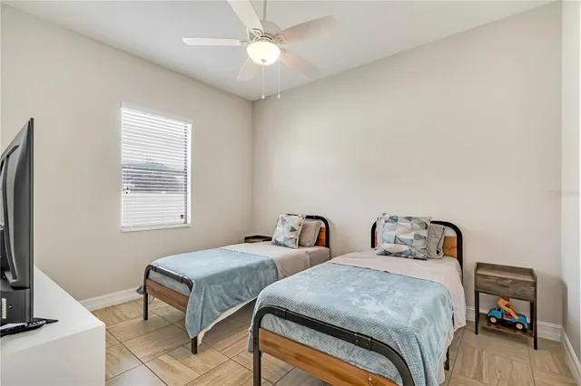 a bedroom with two beds and a couch