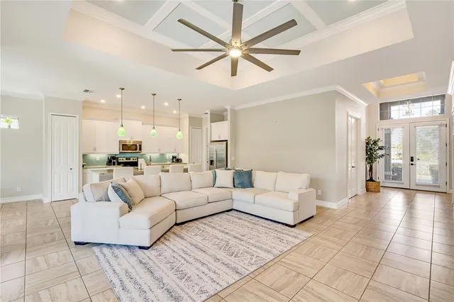 a living room with furniture and a view of kitchen