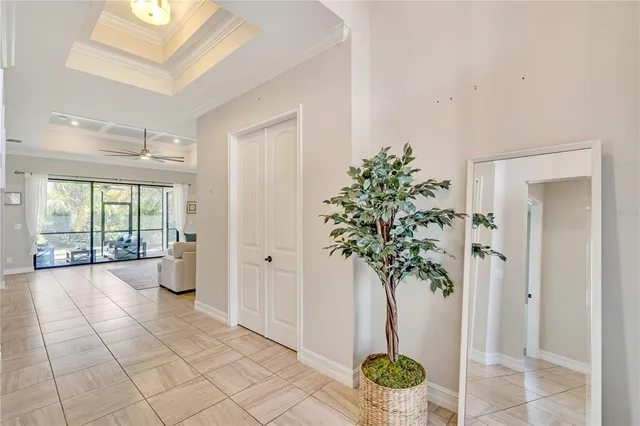 a view of a hallway with windows and flower pot