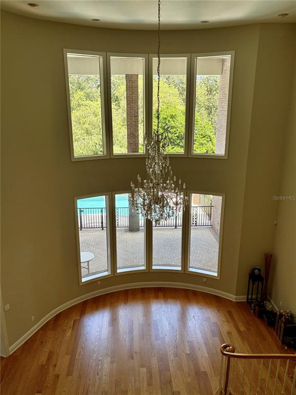 2817 Roehampton Close Tarpon Springs, FL 34688 - Photo 4 of 4 a view of an empty room with a window and wooden floor