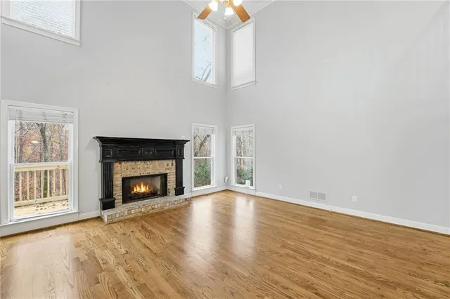 a view of an empty room and a chandelier fan