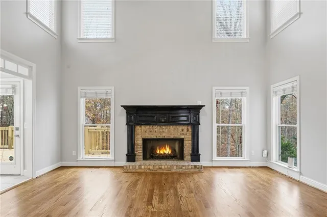 an empty room with windows and chandelier fan