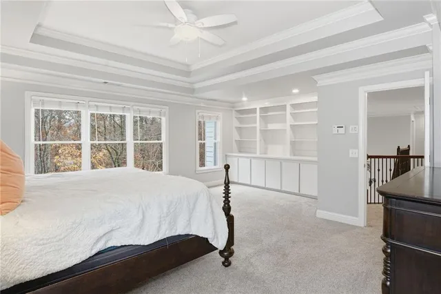 a backyard of a house with fountain table and chairs