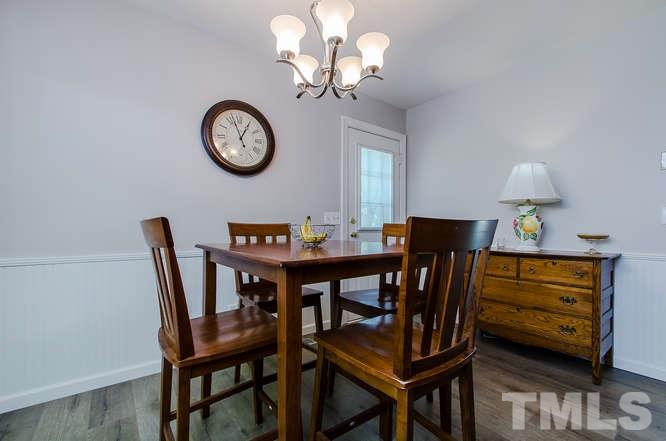 1020 Mockingbird Drive Raleigh, NC 27615 - Photo 8 of 25 a view of a dining room with furniture and a chandelier