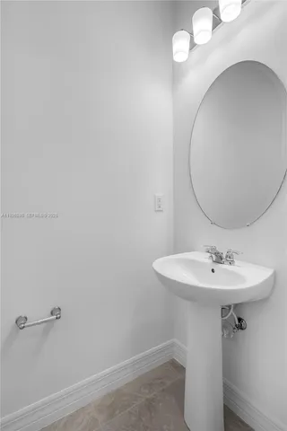 a bathroom with a sink a mirror and shower