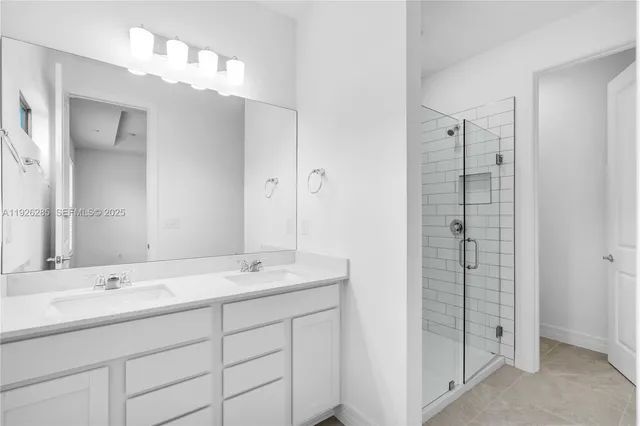 a bathroom with a shower sink and mirror