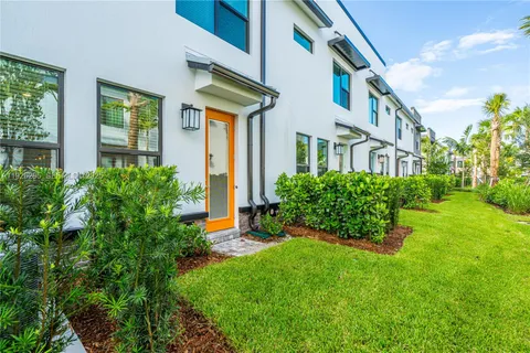 a sign that is sitting in front of a big yard