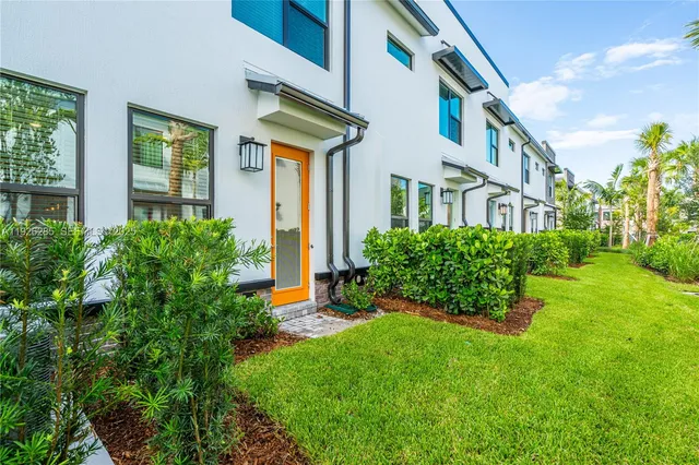 a sign that is sitting in front of a big yard