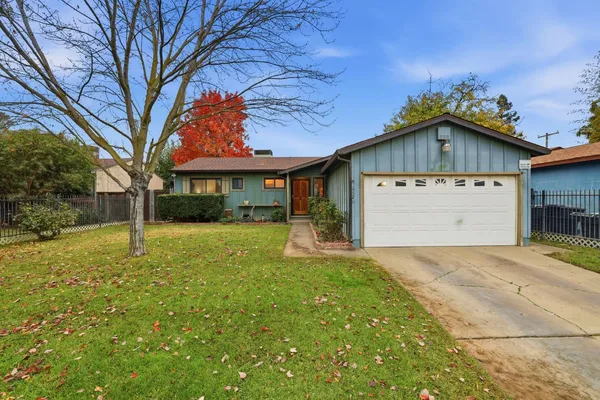 a front view of a house with a yard and garage