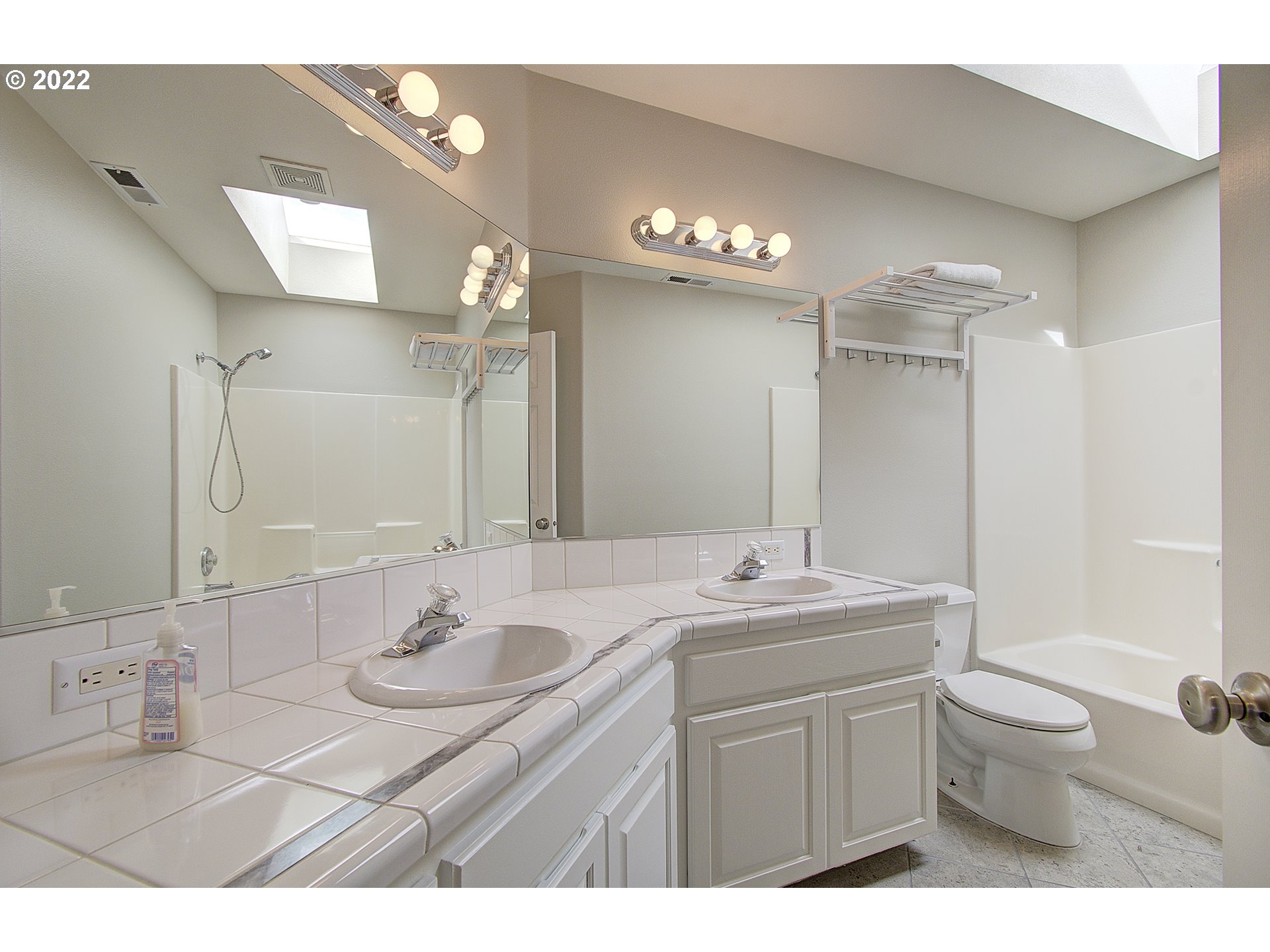 16017 Northeast 26th Court Ridgefield, WA 98642 - Photo 23 of 31 a bathroom with a granite countertop sink a toilet and a mirror
