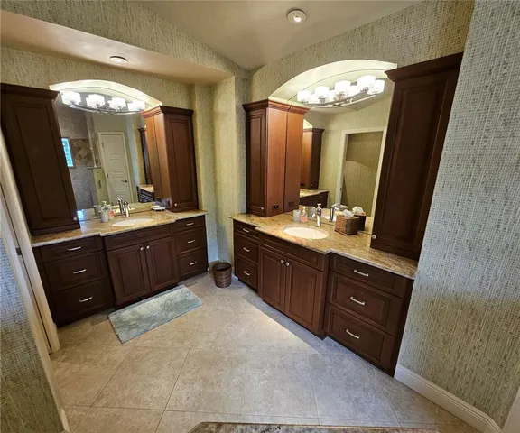 a spacious bathroom with a double vanity sink and a mirror