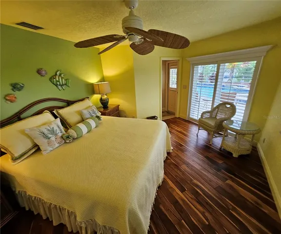 a bed sitting in a bedroom next to a window