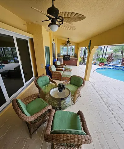 a view of a swimming pool with an outdoor seating