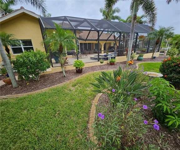 a view of a house with swimming pool and sitting area