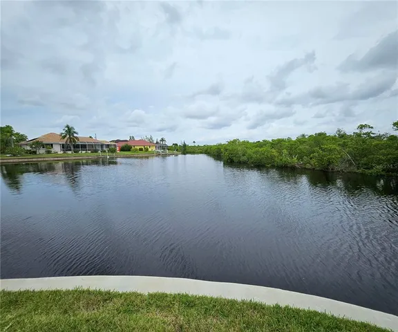 a view of a lake with houses in the back
