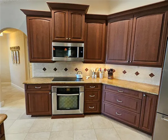 a kitchen with stainless steel appliances granite countertop a stove and a microwave