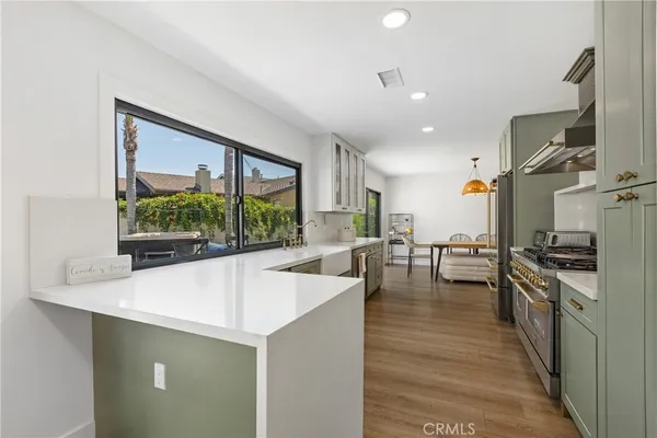 a kitchen with counter top space a sink and stainless steel appliances