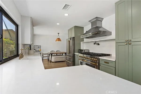 a kitchen with stainless steel appliances granite countertop a stove and a refrigerator