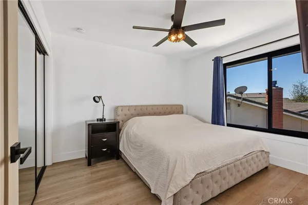 a bedroom with a bed and wooden floor