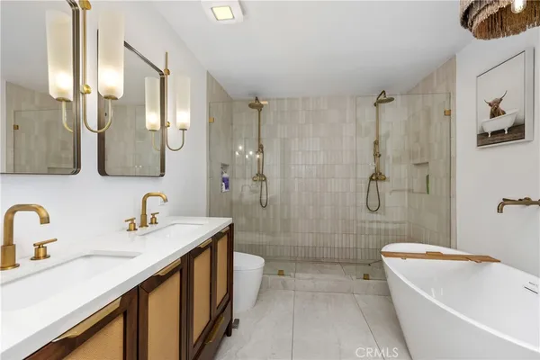 a bathroom with a tub sink toilet and shower