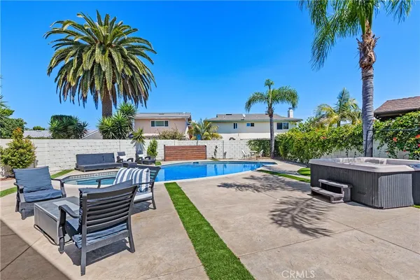 a view of a backyard with plants and a patio