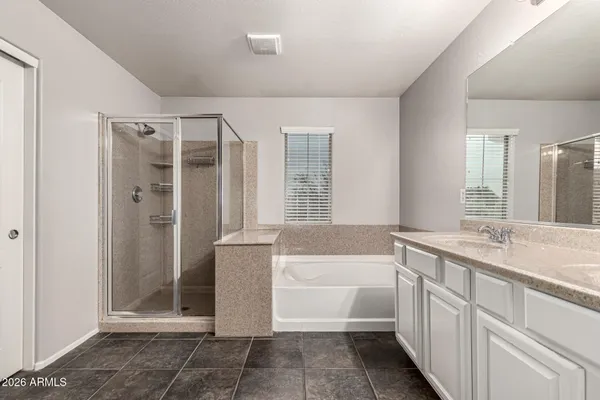 a bathroom with a tub sink and mirror