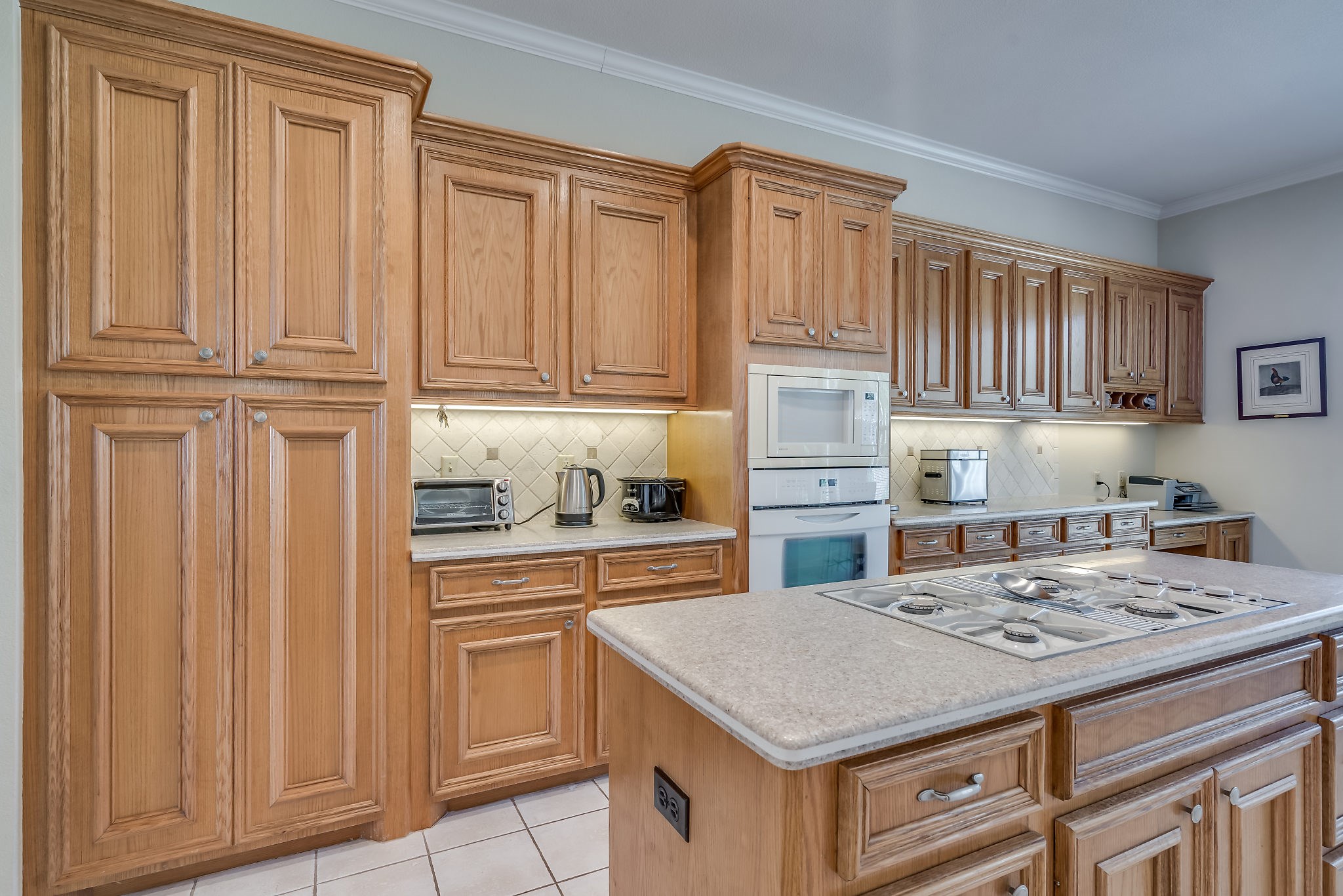 2500 Centerline Road Conroe, TX 77384 - Photo 13 of 28 a kitchen with kitchen island granite countertop wooden cabinets and white appliances