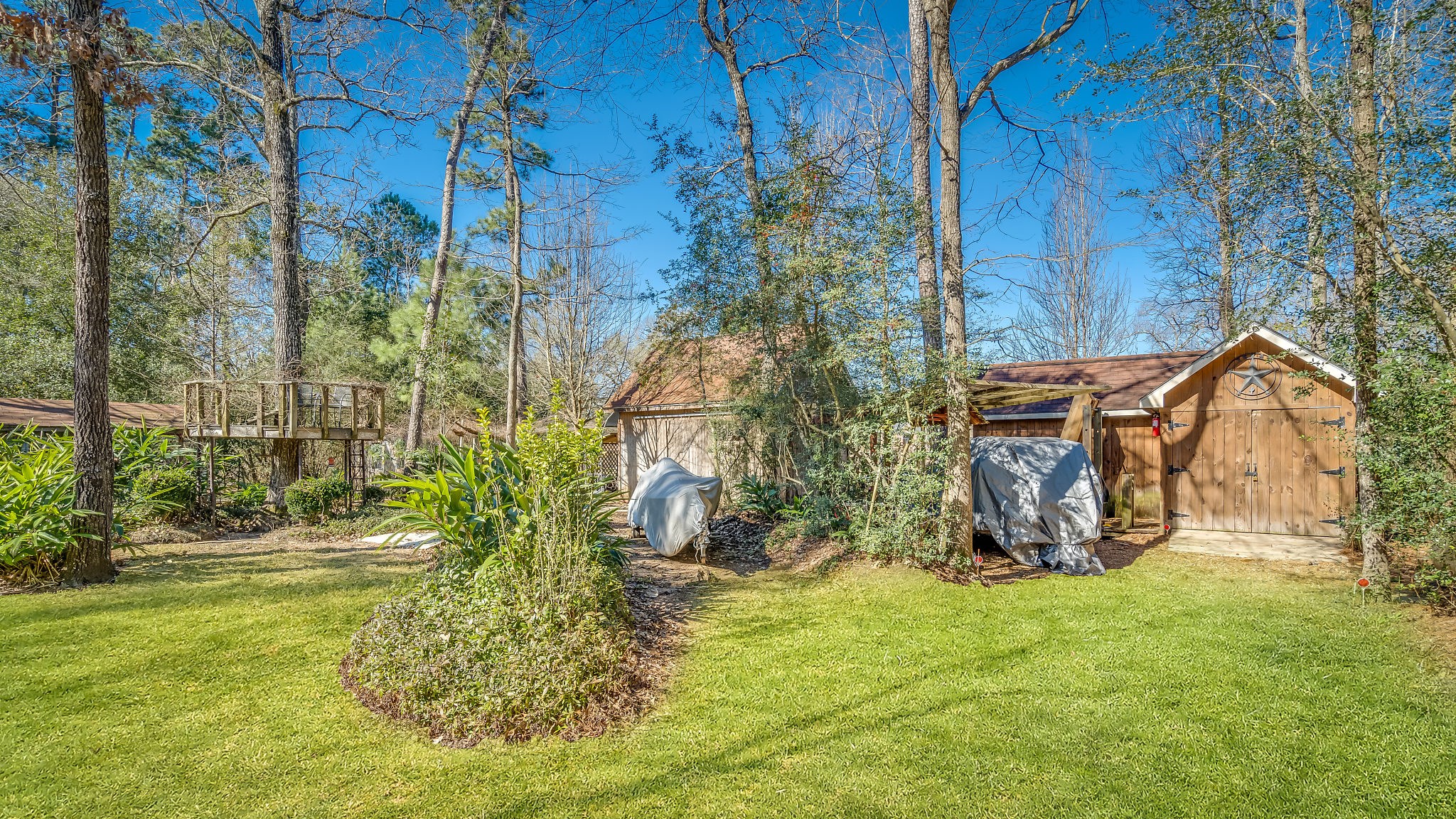 2500 Centerline Road Conroe, TX 77384 - Photo 27 of 28 a backyard of a house with lots of green space and garden