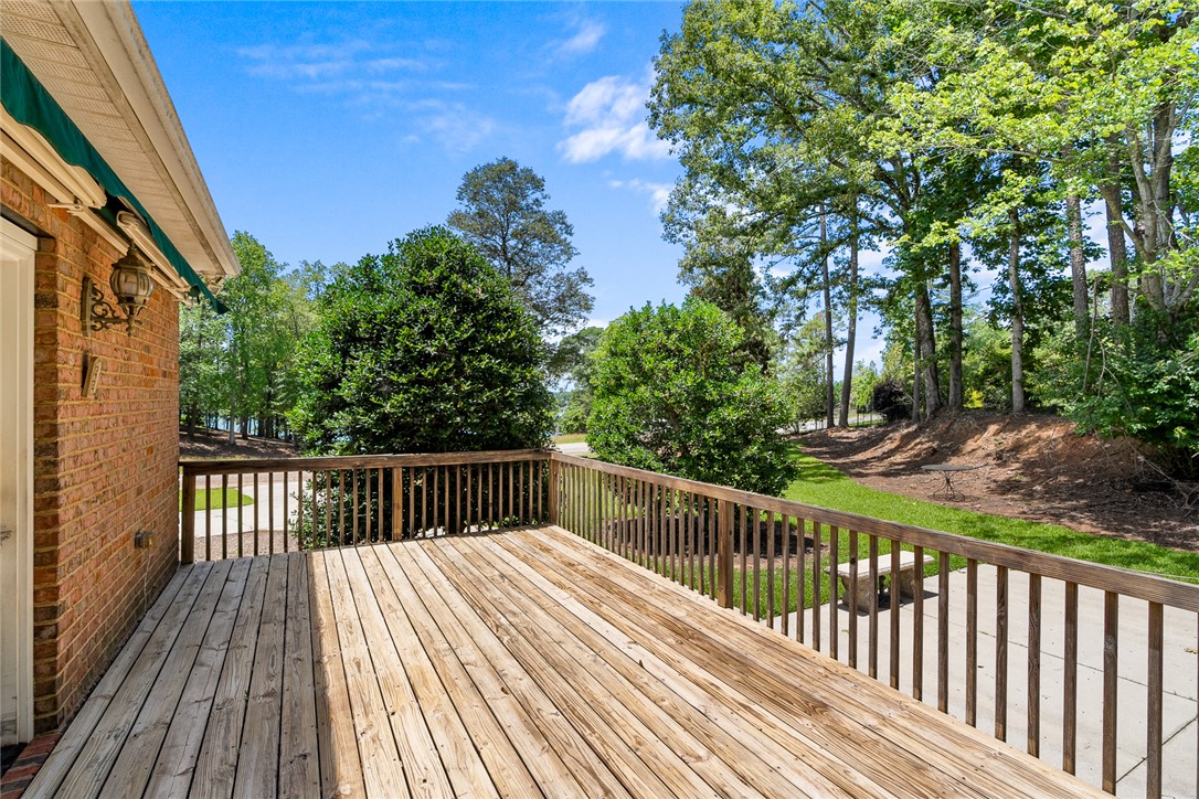 135 Sunset Bay Boulevard Seneca, SC 29672 - Photo 44 of 50 A spacious wooden deck provides tranquil outdoor living with views of lush greenery and distant waters.