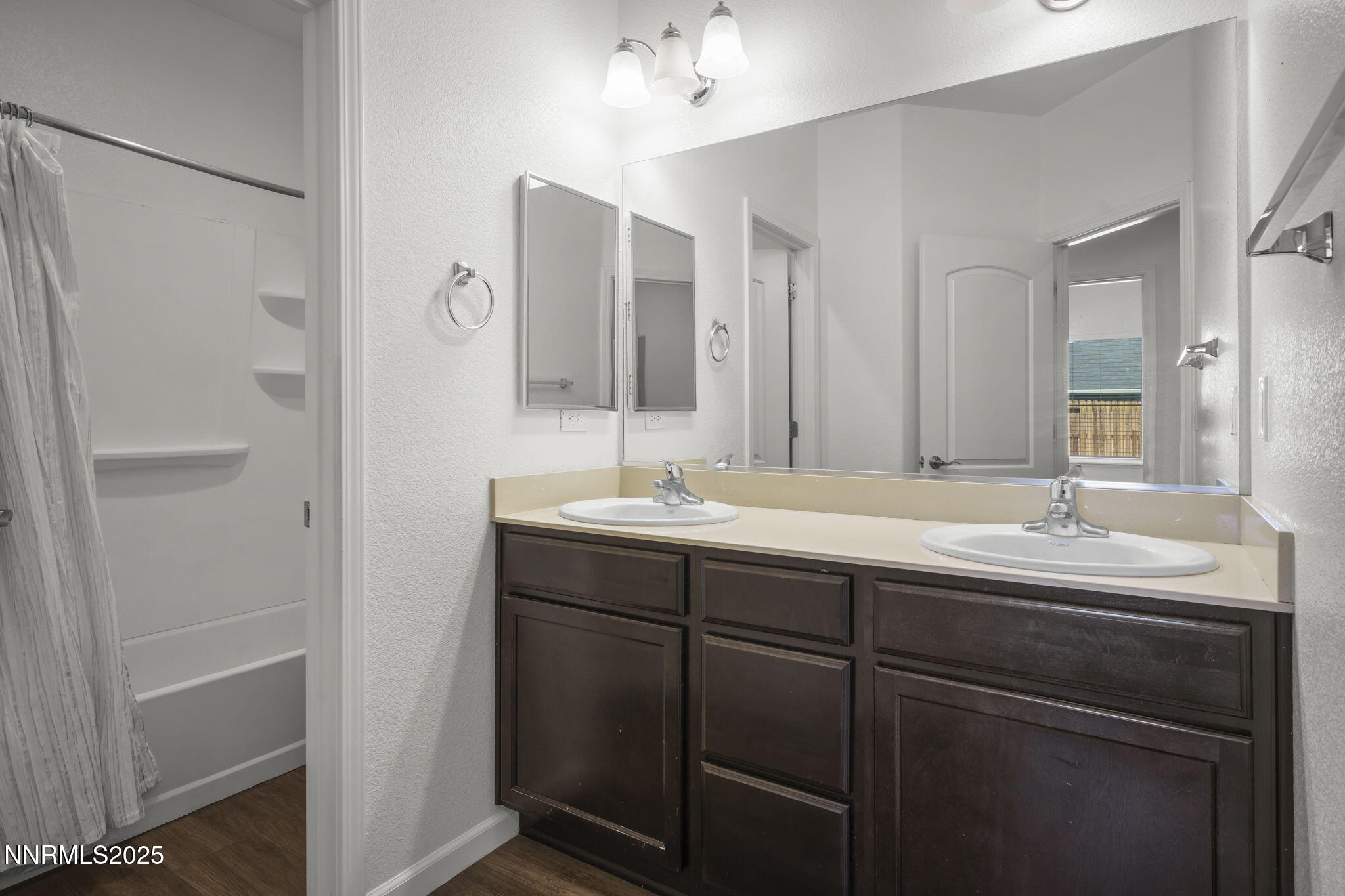 1187 Jasmine Lane Fernley, NV 89408 - Photo 11 of 22 a bathroom with a double vanity sink and mirror