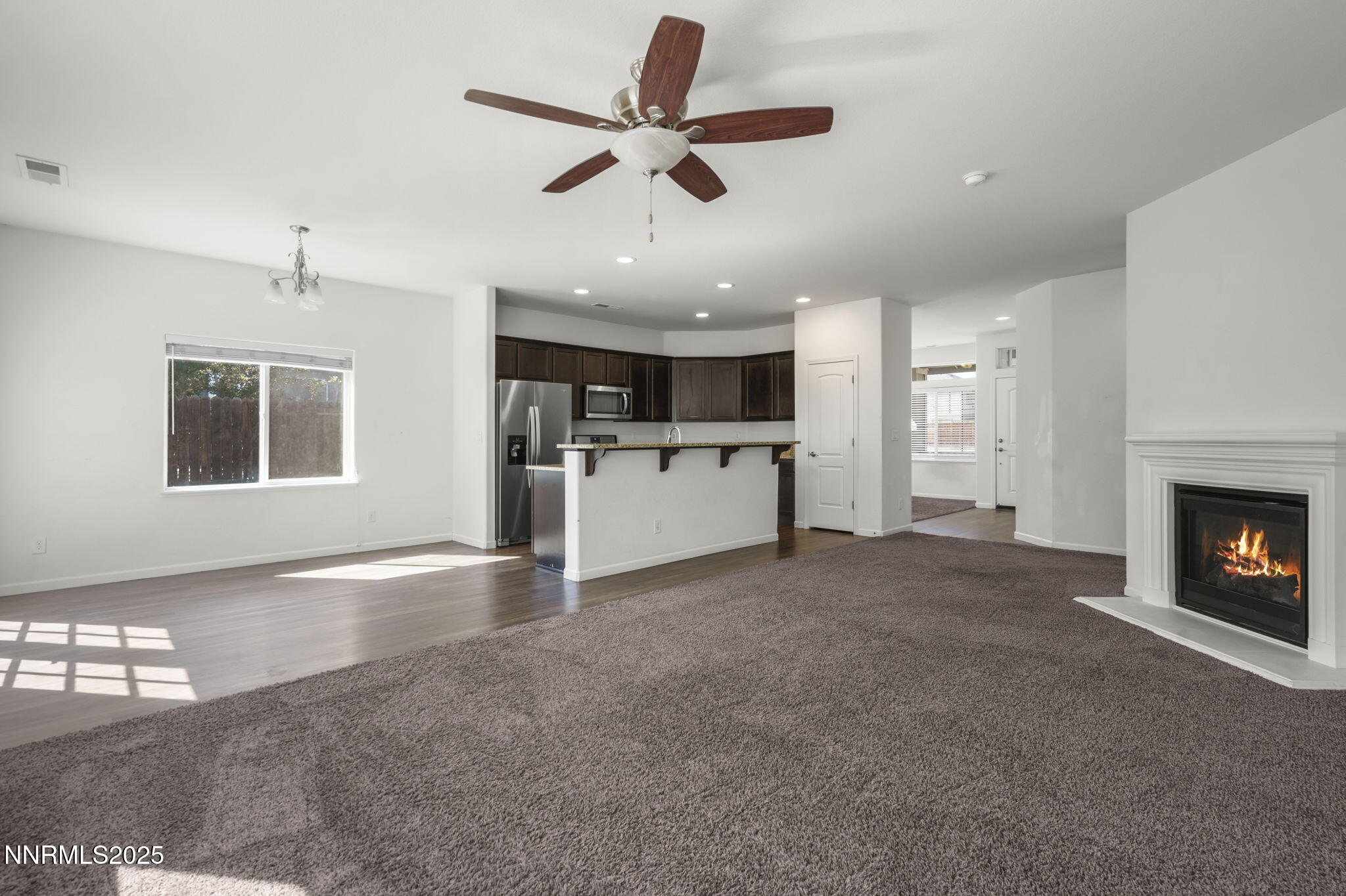1187 Jasmine Lane Fernley, NV 89408 - Photo 6 of 22 a view of a livingroom with a kitchen and a fireplace