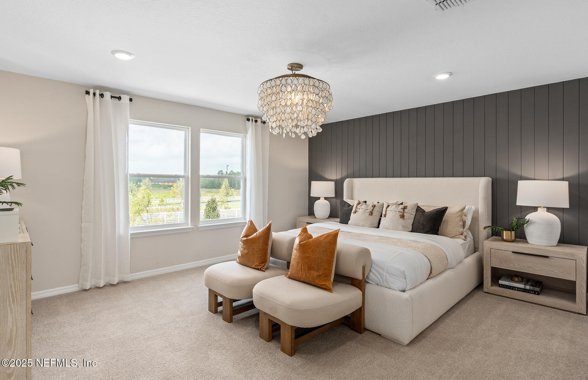 488 Peppervine Way Yulee, FL 32097 - Photo 13 of 17 a spacious bedroom with a bed and a chandelier