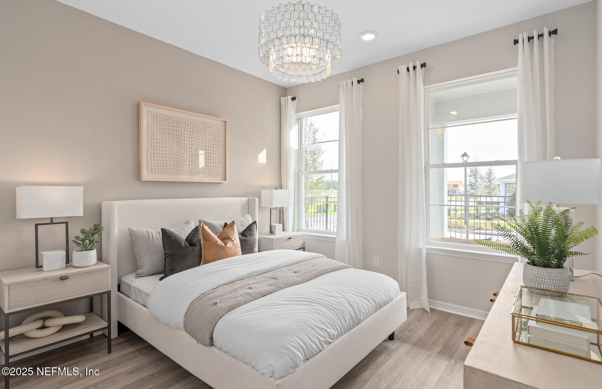 488 Peppervine Way Yulee, FL 32097 - Photo 14 of 17 a bedroom with a large bed and a chandelier