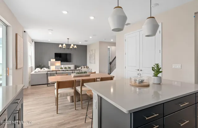 a kitchen with a stove a sink a dining table and chairs