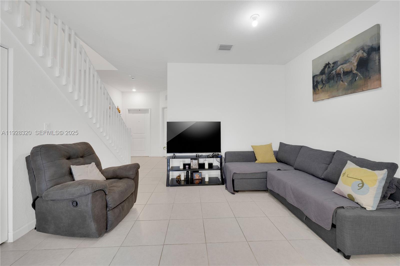 16266 Southwest 291st Street Homestead, FL 33033 - Photo 12 of 34 a living room with furniture and a flat screen tv