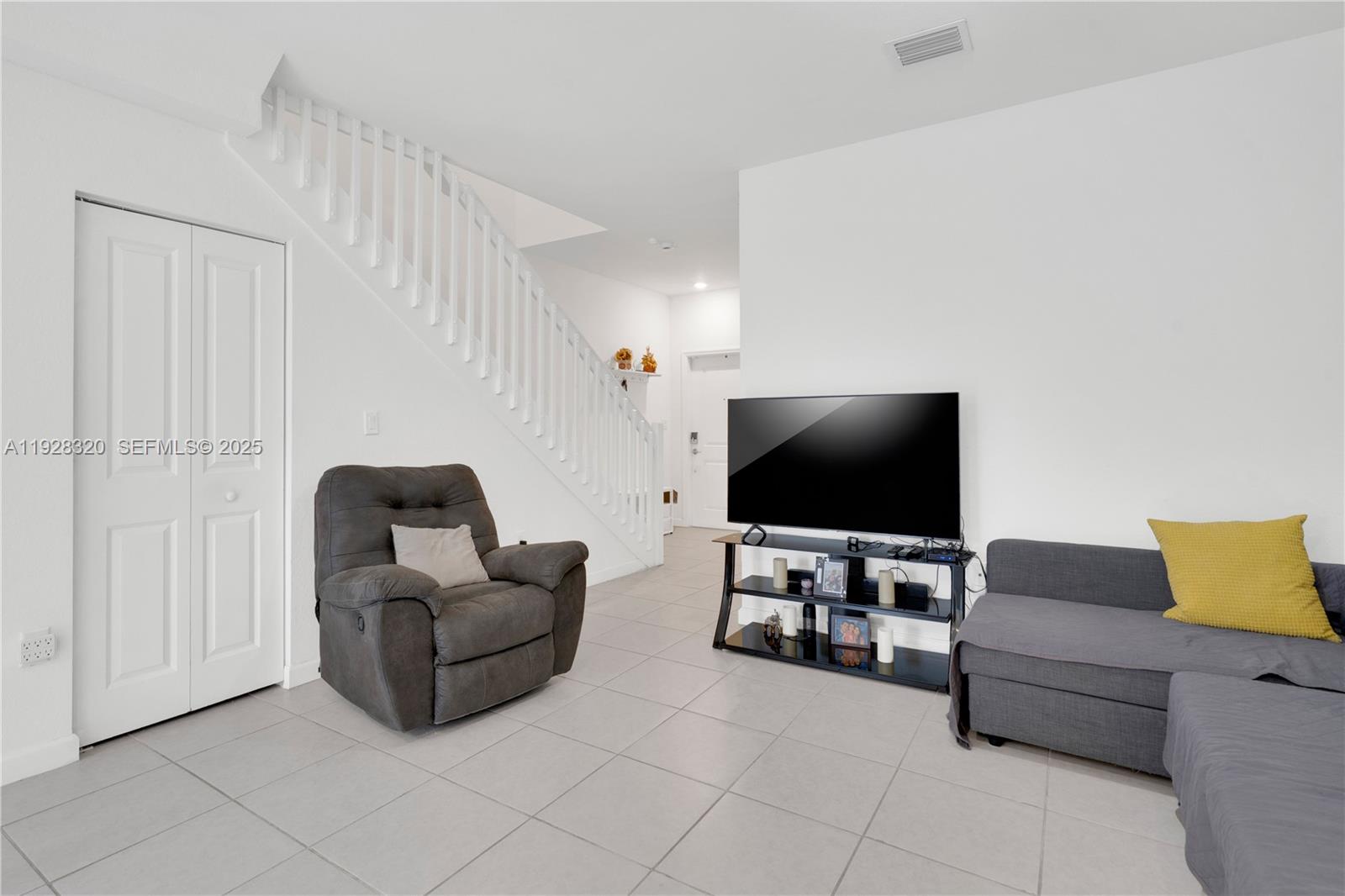 16266 Southwest 291st Street Homestead, FL 33033 - Photo 13 of 34 a living room with furniture and a flat screen tv