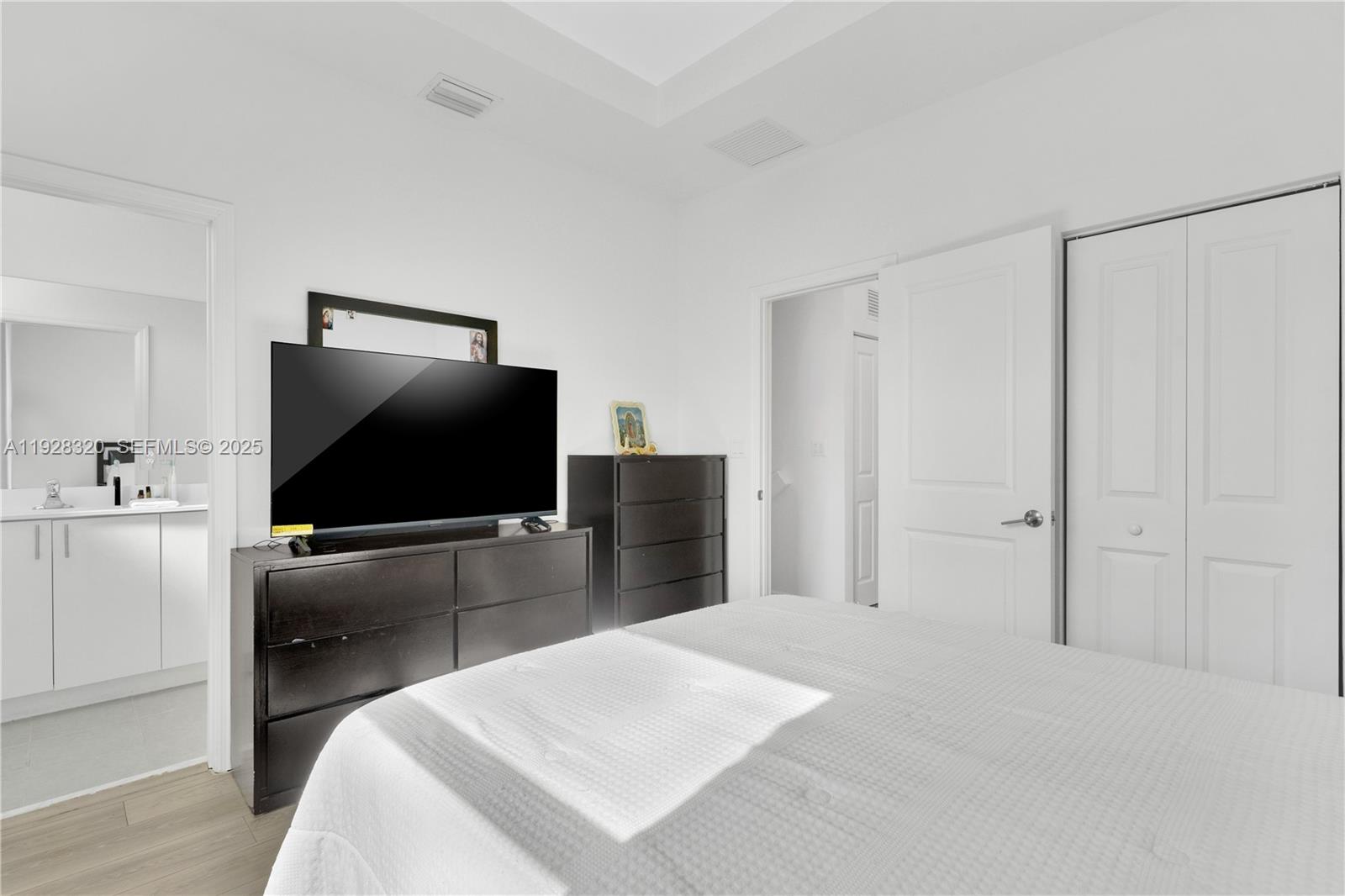 16266 Southwest 291st Street Homestead, FL 33033 - Photo 16 of 34 a bedroom with a bed and a flat screen tv