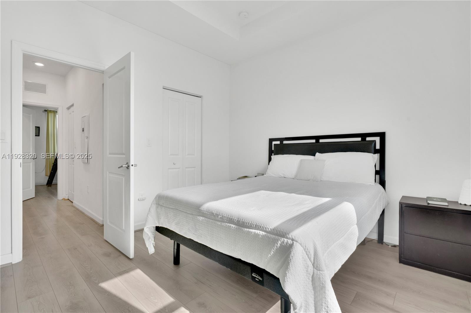 16266 Southwest 291st Street Homestead, FL 33033 - Photo 17 of 34 a bedroom with a bed and a chandelier