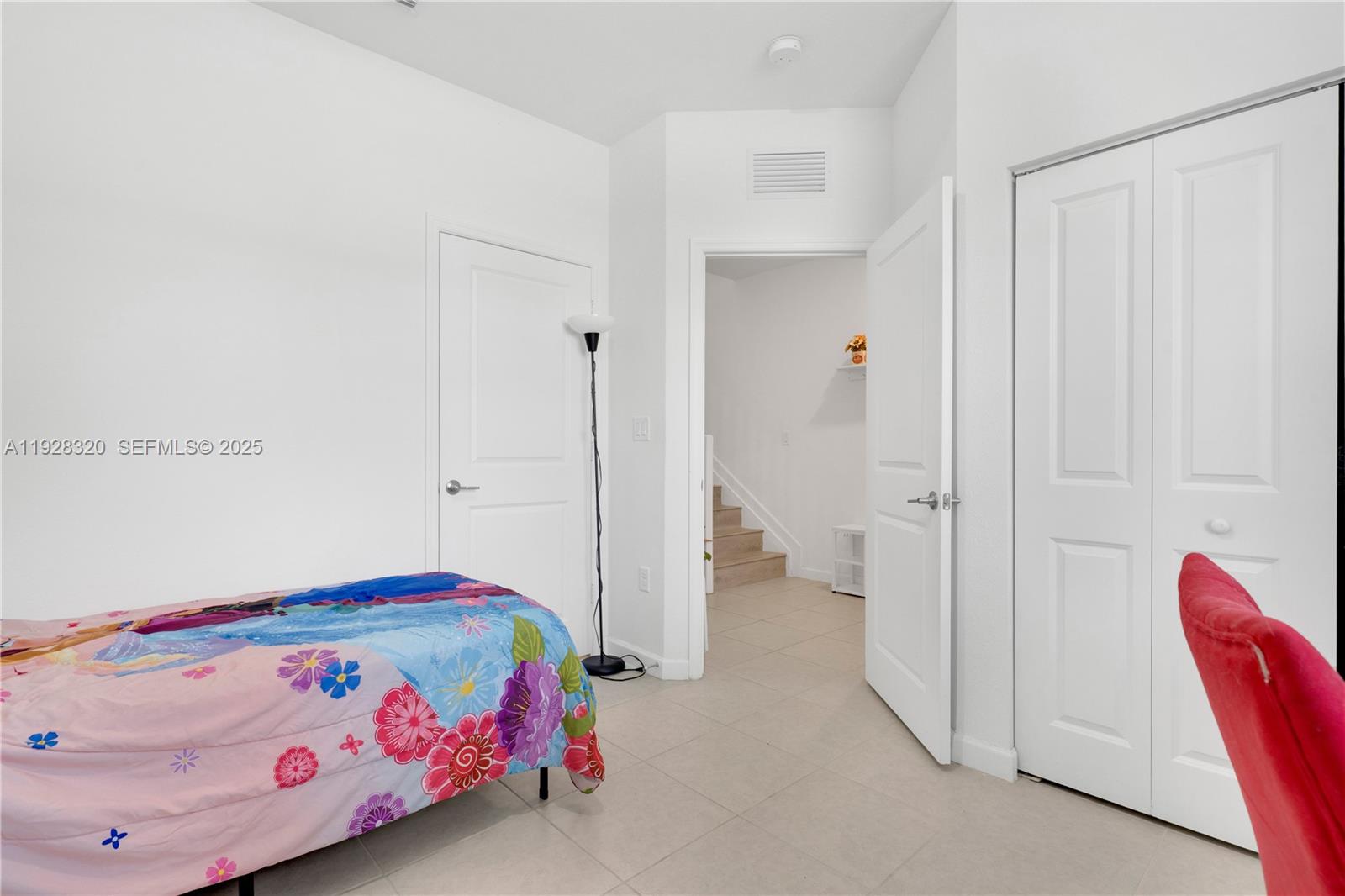 16266 Southwest 291st Street Homestead, FL 33033 - Photo 24 of 34 a bedroom with a bed and a chandelier