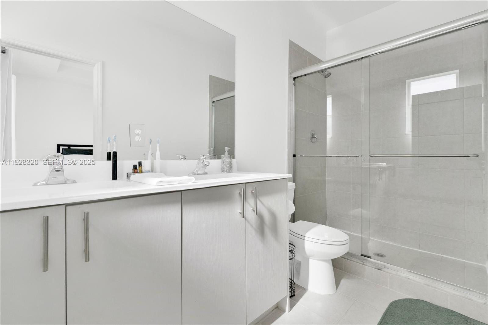 16266 Southwest 291st Street Homestead, FL 33033 - Photo 25 of 34 a bathroom with a sink toilet and shower