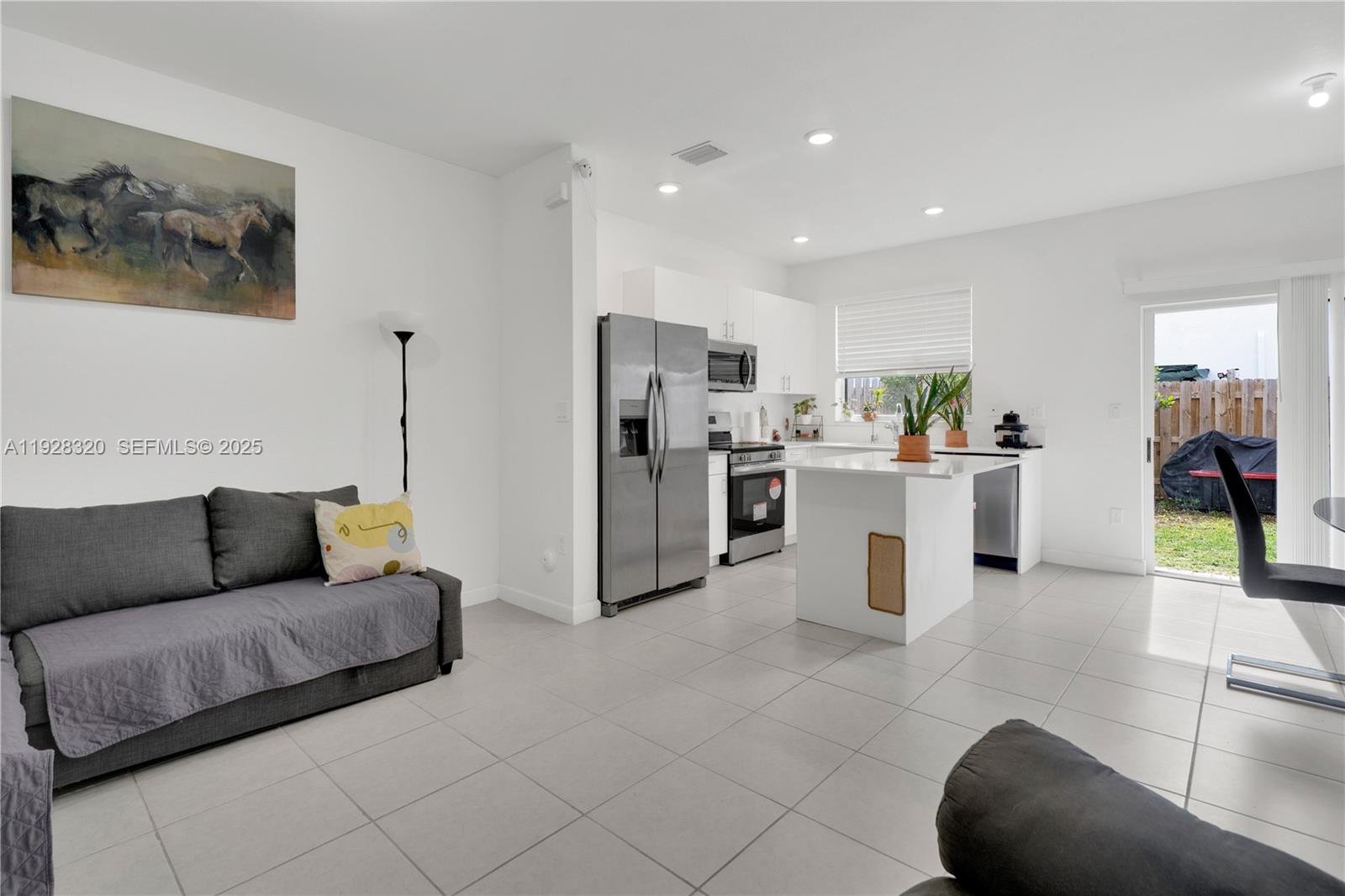 16266 Southwest 291st Street Homestead, FL 33033 - Photo 3 of 34 a living room with furniture and kitchen view